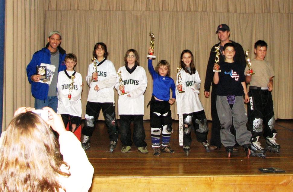 Ducks players hold their trophies proudly in the small gym after winning the Palisades Recreation Center Roller Hockey League championship. Photo courtesy of Bob Kahn